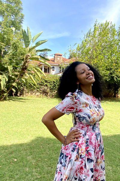Black woman with curly hair smiling