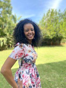 Black woman with curly hair smiling